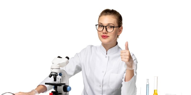 front-view-female-doctor-white-medical-suit-sitting-front-table-with-solutions-light-white-space